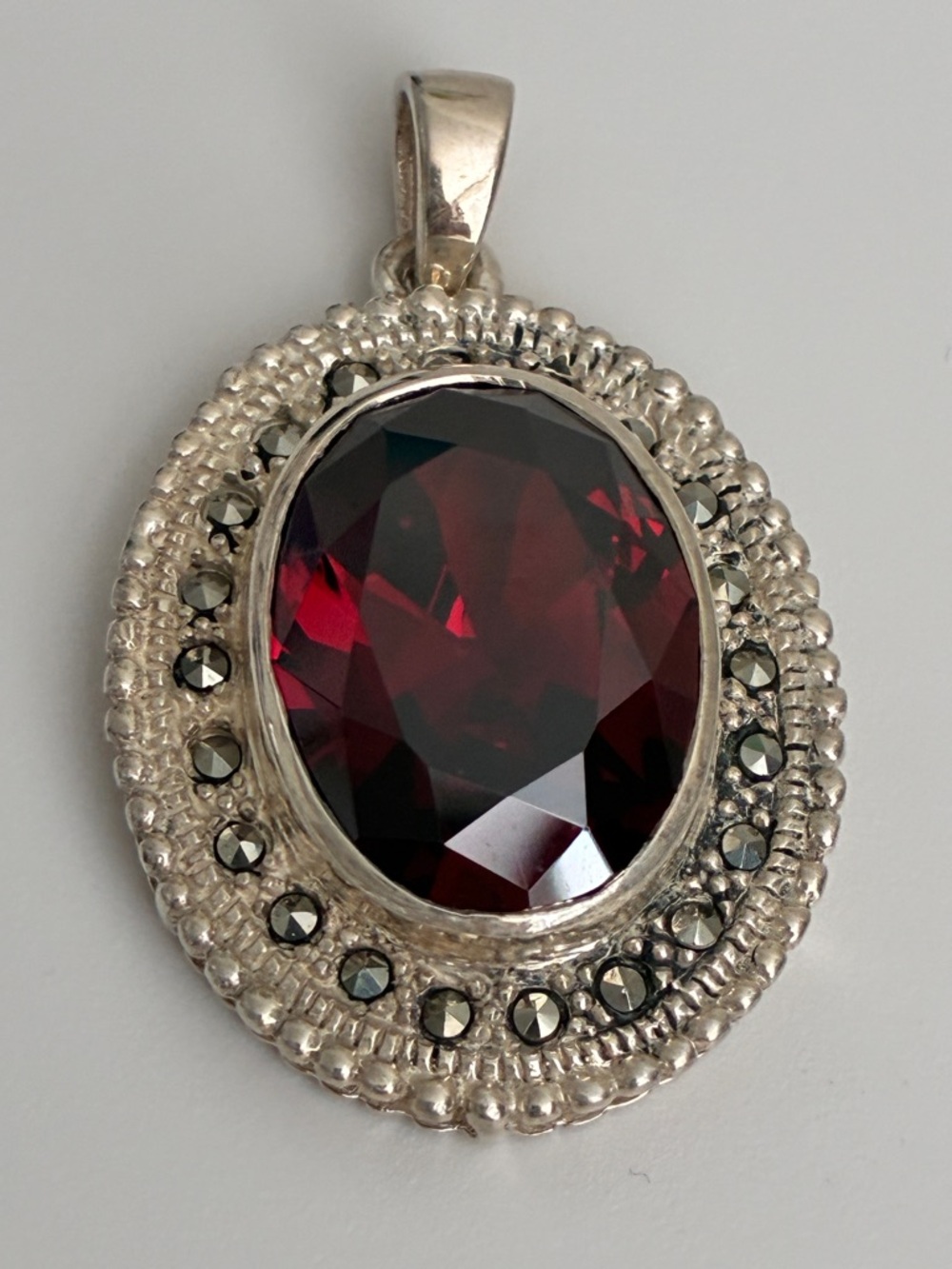 Elegant Silver Pendant with Deep Red Faceted Stone